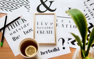 printed poster designs laid out on table